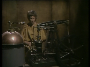 A young Peter Duncan, as Roman Briton Cotus, inspects a steam apparatus in A Rift in Time (1974)