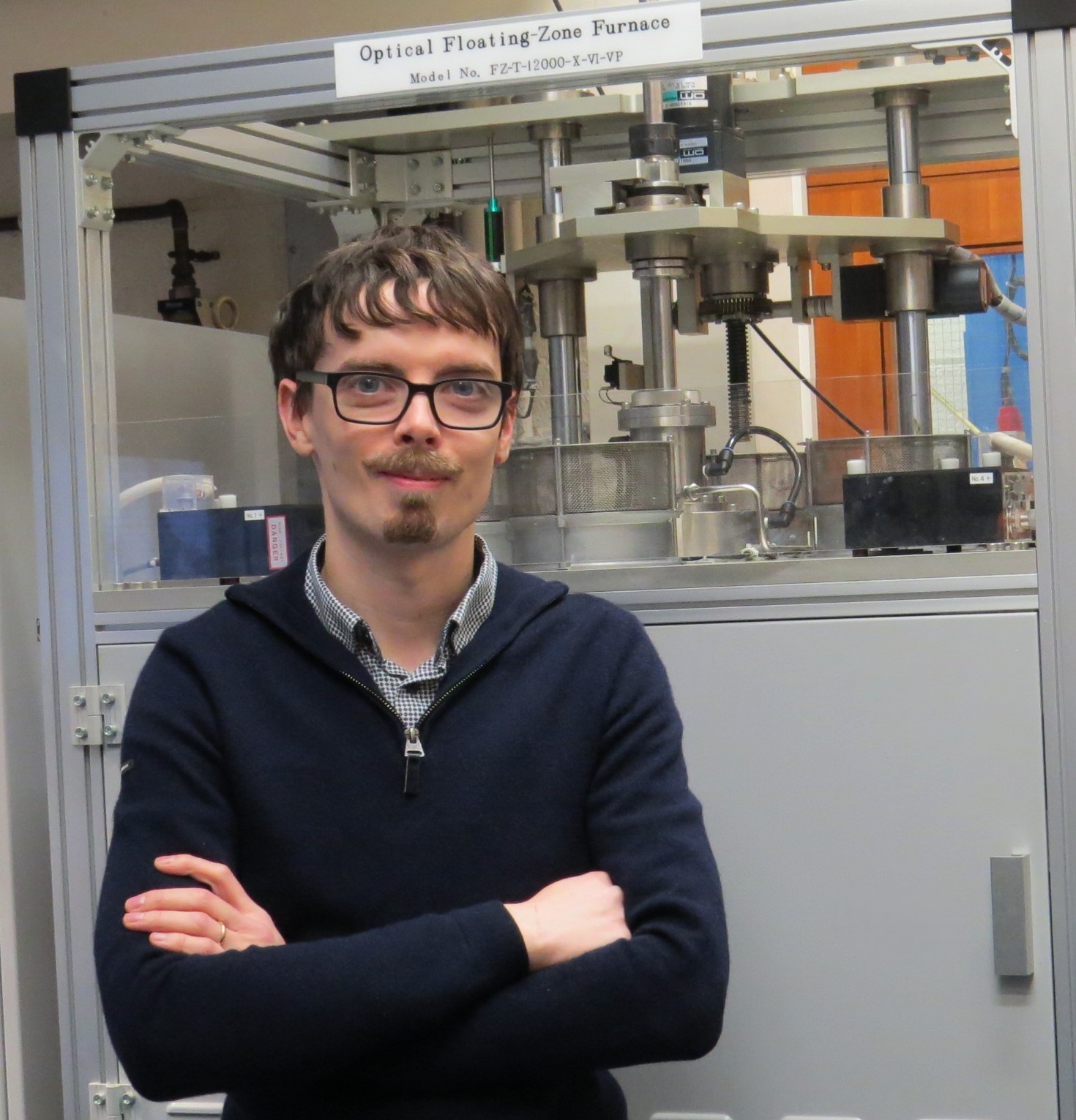 Dr Daniel Mayoh in front of floating zone furnace
