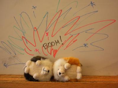 two toy hedgehogs in complimentary colours having a collision