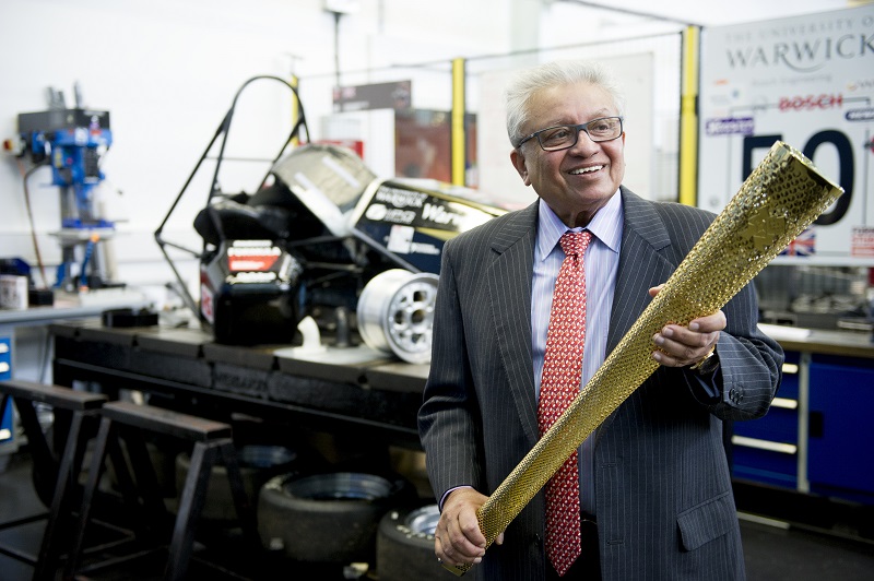 Professor Lord Bhattaycaryya with the Olympic torch with WMG helped to make lightweight