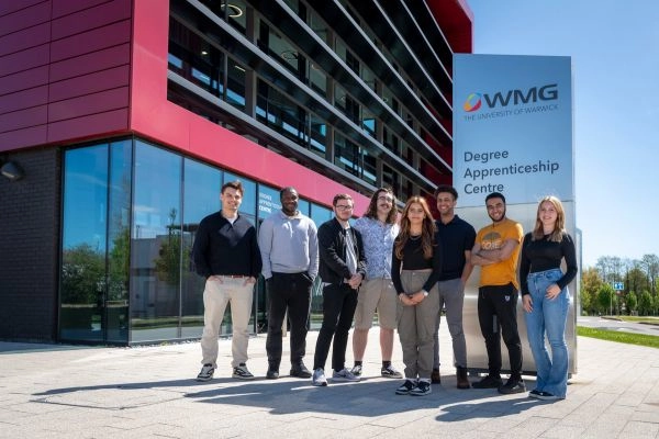 A group of students stand outside the WMG Degree Apprenticeship Centre at the University of Warwick