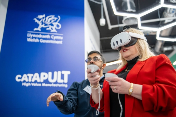 Two people taking part in a virtual reality demonstration using controllers and a headset