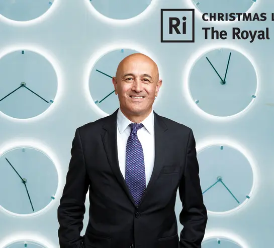 A picture of Jim Al-Khalili with clocks in the background.
