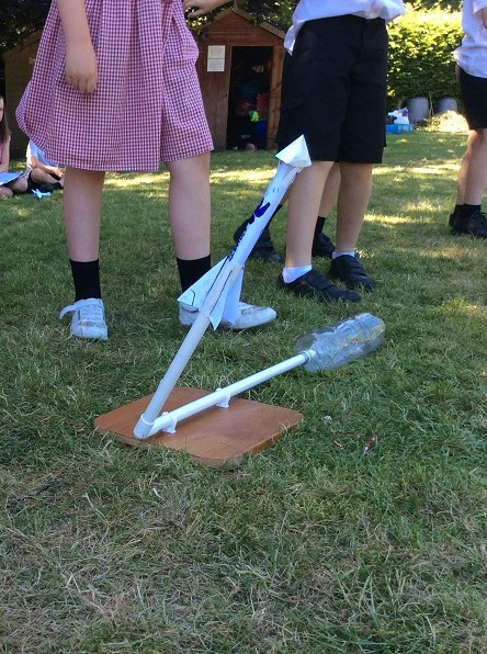 students with a rocket they can launch by stomping on a bottle