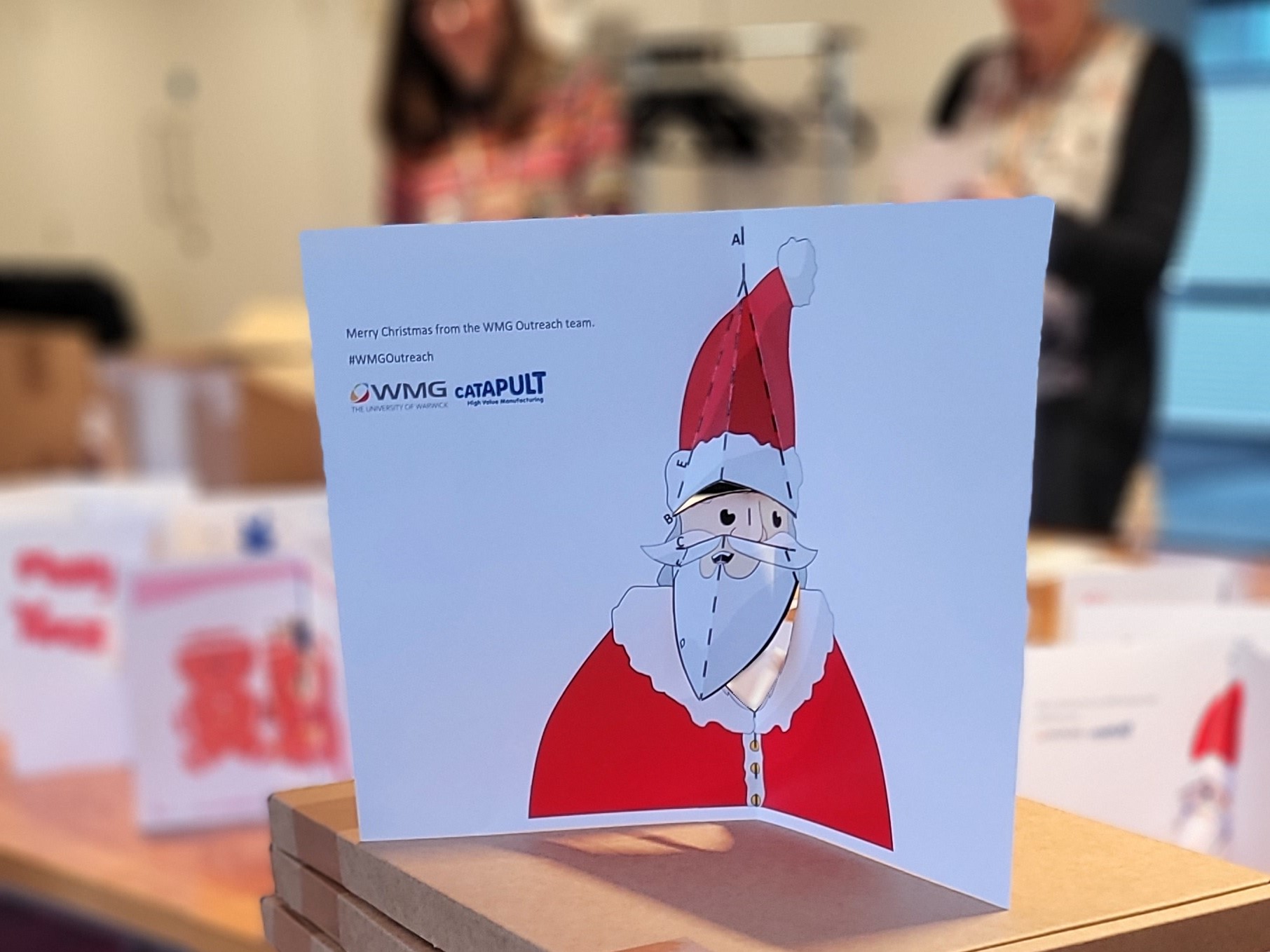 a pop-up card shows Father Christmas with his beard and hat popping out from the card.