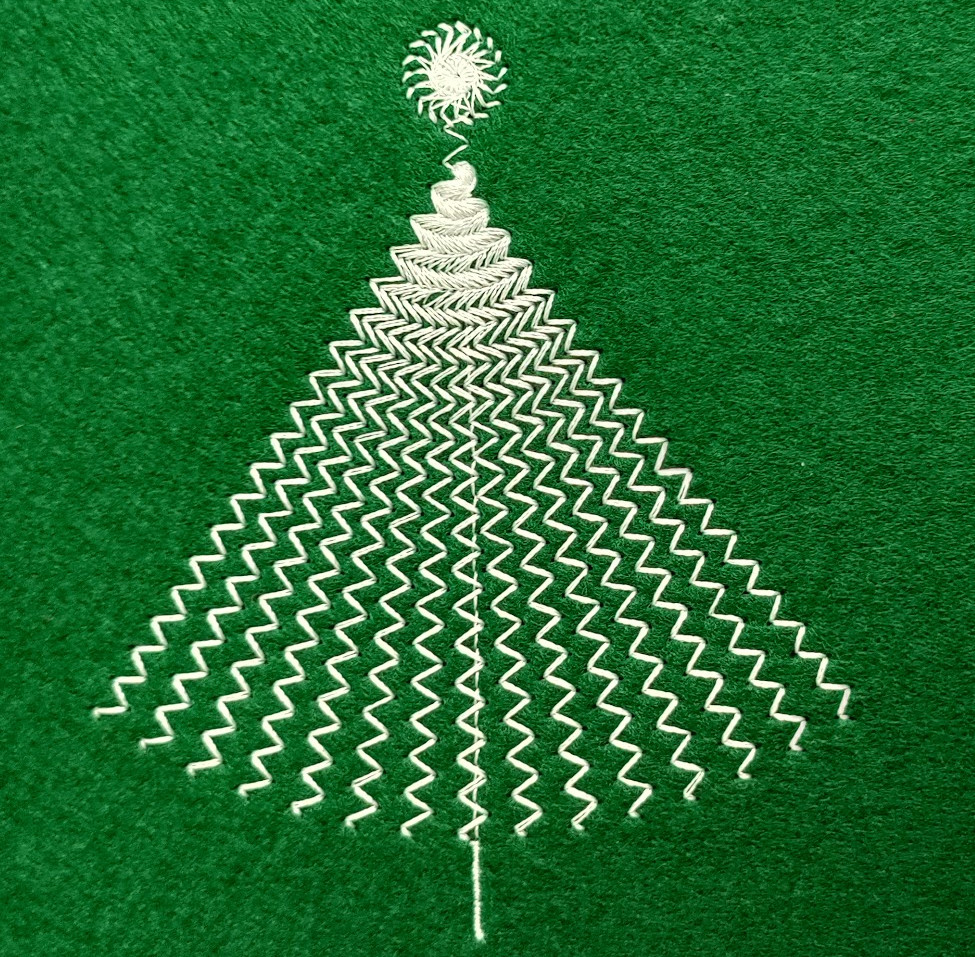 A stylised version of a christmas tree, stitched in white thread on a green background
