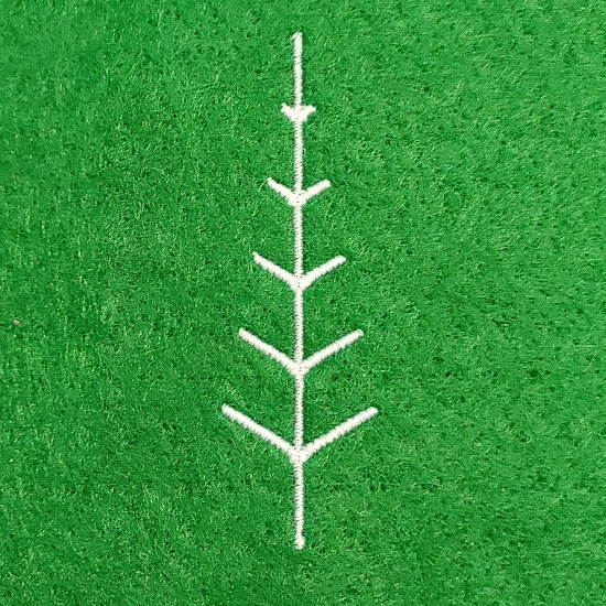 a simple tree with branches getting smaller as it gets to the top of the tree.  Stitched in white thread on a green background.