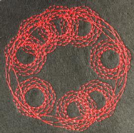 An example of a primary school childs work.  Its their pattern designed using turtlestitch, stitched onto brown felt with red thread.  Its a series of circular patterns 