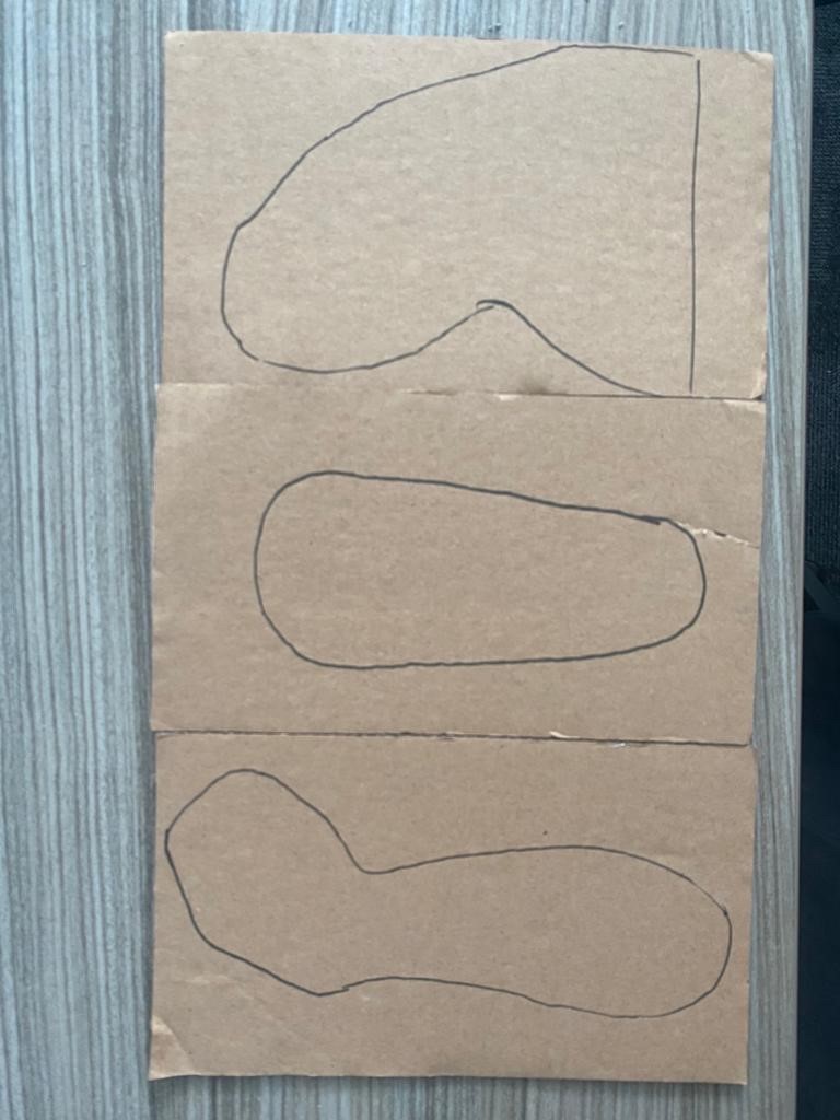 3 muscle shapes drawn onto cardboard with a black pen