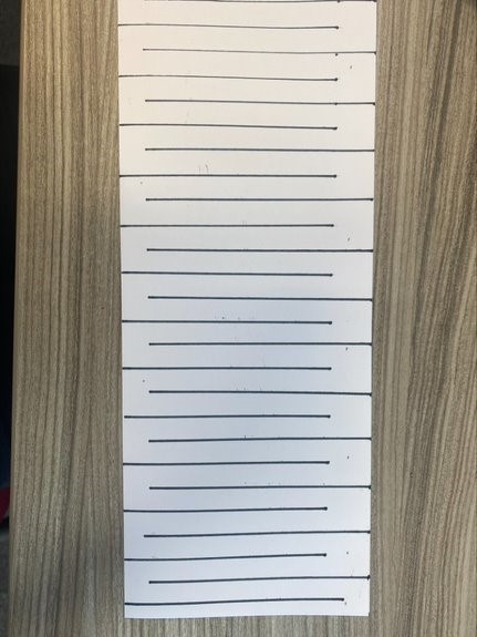 a4 paper folded in half lengthwise with alternating lines drawn on