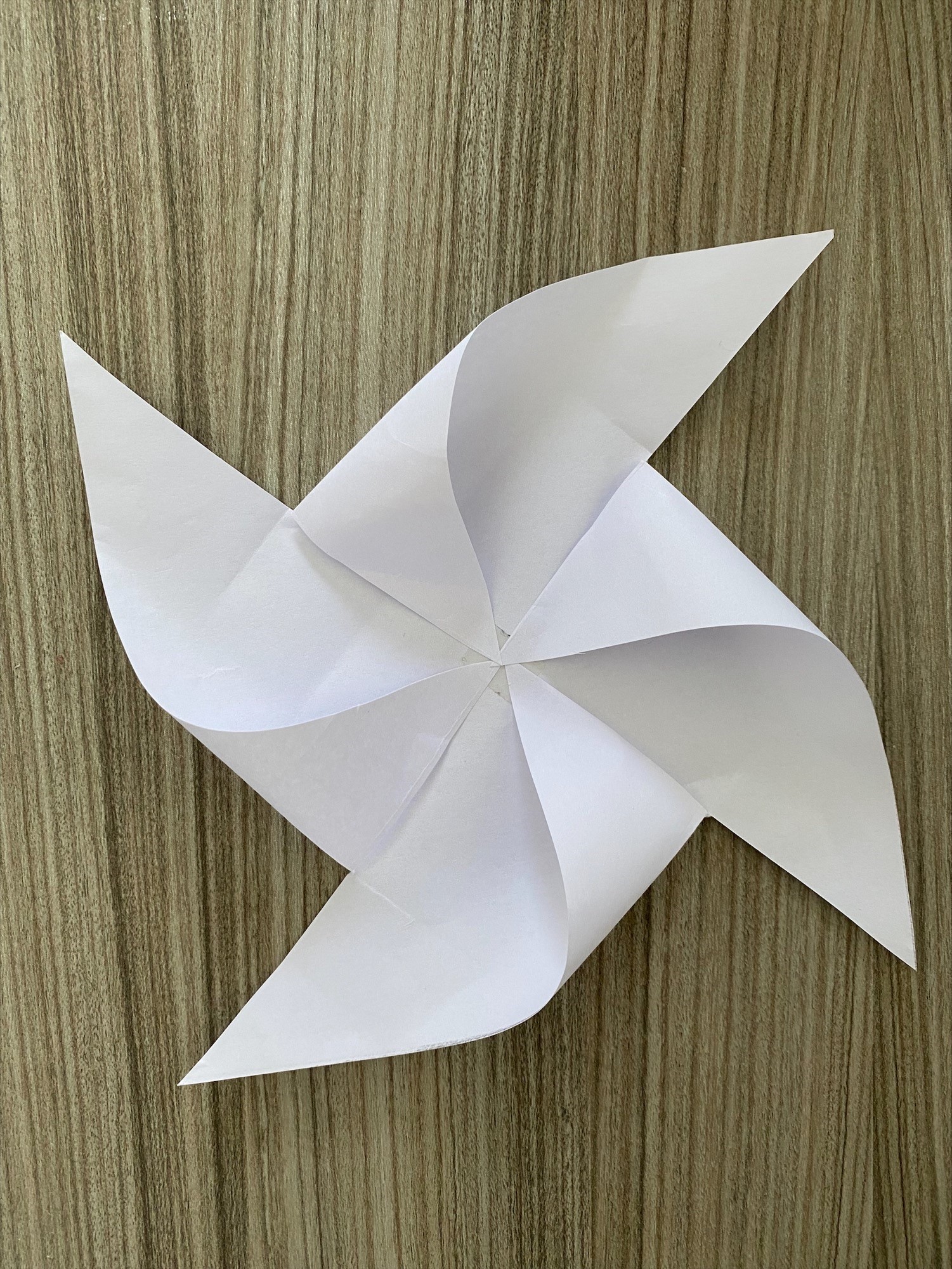Square piece of paper with every other corner folded into the center to make a windmill