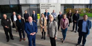 Front, Cllr O’Boyle with Margot James and partners from organisations across Coventry congregating outside the Prof. Lord Bhattacharyya building home to NAIC the National Automotive Innovation Centre at WMG, University of Warwick