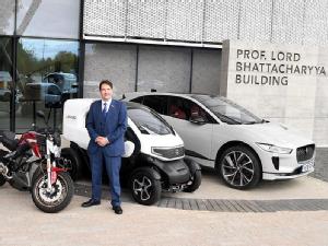Professor David Greenwood with Electric Vehicles outside NAIC. 