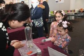 Picture shows Yiduo Wang presenting a science experiment at the Slice of Science event