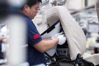 Employee working on a car seat. 