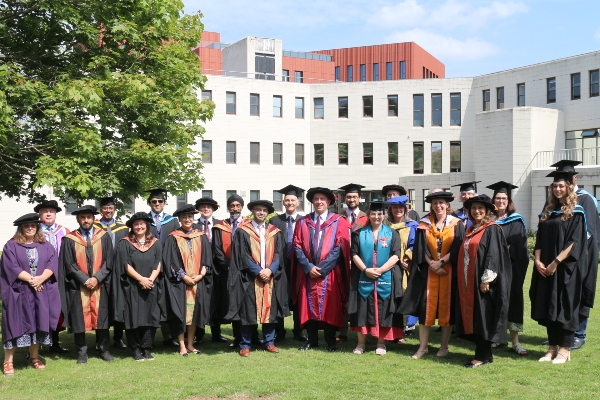 Academic staff dressed in ceremonial robes for graduation. 
