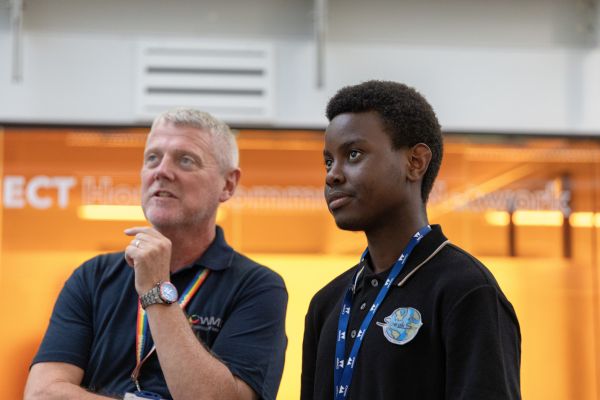 A student stands next to the Dean of WMG at a showcase event