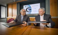 Professor Bhattacharyya exchanges the signed agreement with Professor Acharya