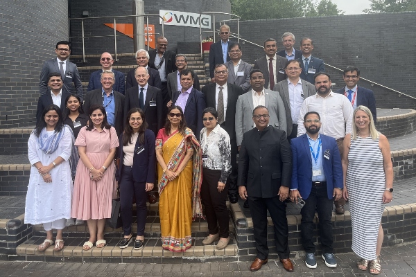 Members of CII smiling with WMG staff outside WMG building