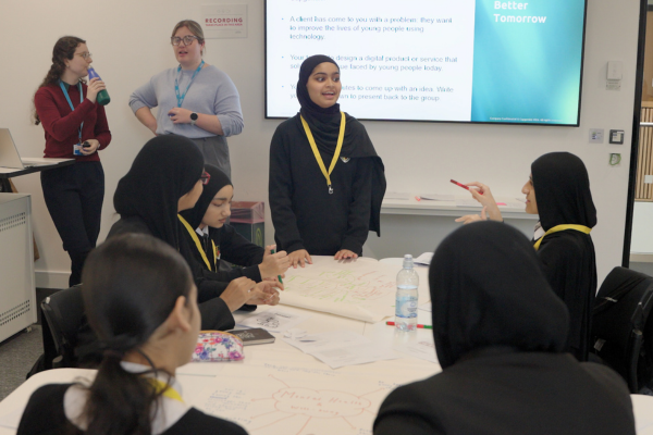 Female students with head coverings work together to solve a real-life engineering problem