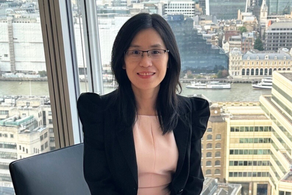 Dr Li smiling to camera with River Thames in the background