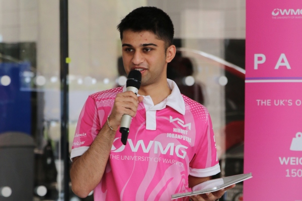 Nirmit Jobanputra, Student Leader and Chief Engineer at Warwick Moto, speaks into microphone at bike launch event. 