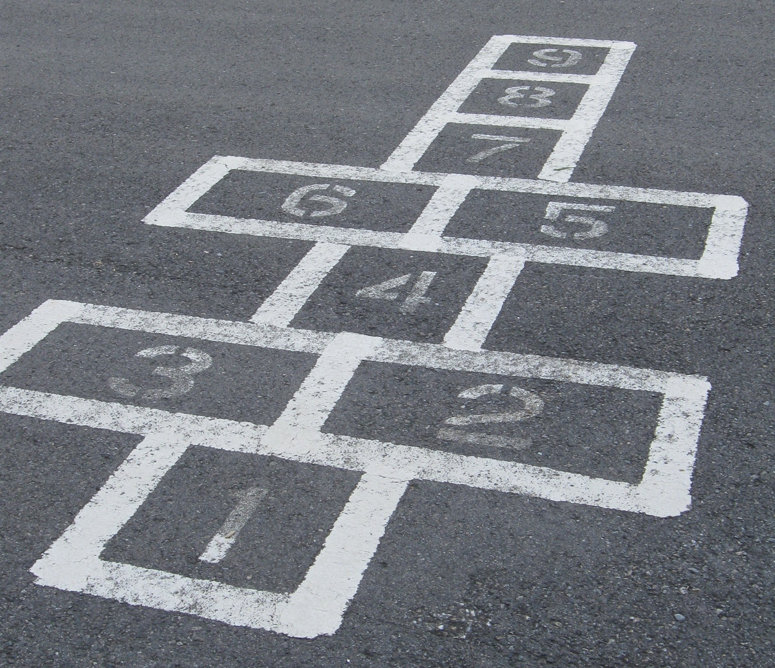 a painted hopscotch framework in a children's playground
