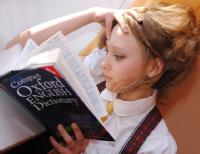 Young student reading an English dictionary