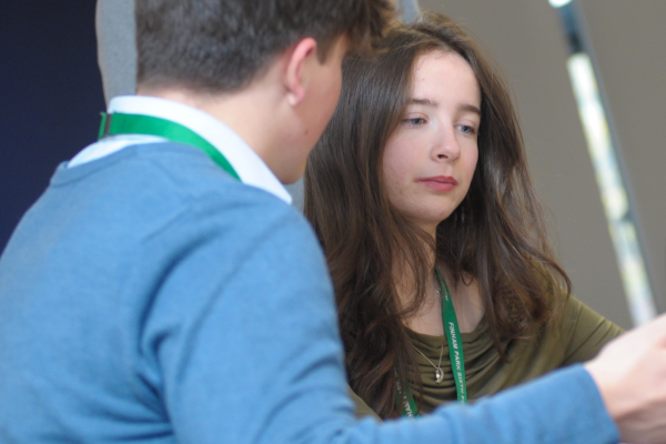 Students discussing work in front of them