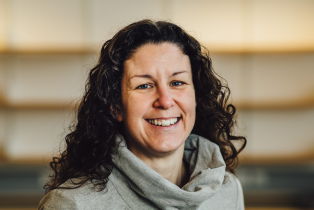 Becki Coombe photo - woman with dark curly hair