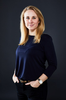 Jeanie Davies photo - woman with blonde, shoulder-length hair wearning a dark blue top and trousers and smiling at the camera