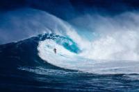 Tiny surfer riding a very big wave
