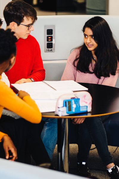 group of students looking at a desk