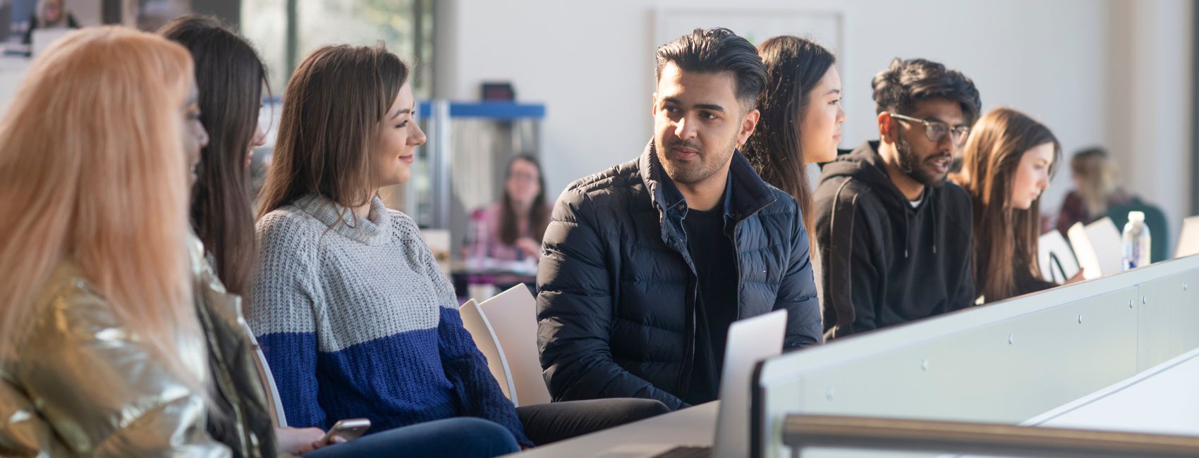 students talking whilst sat at a table