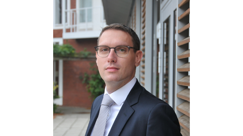 white male with glasses in shirt and tie