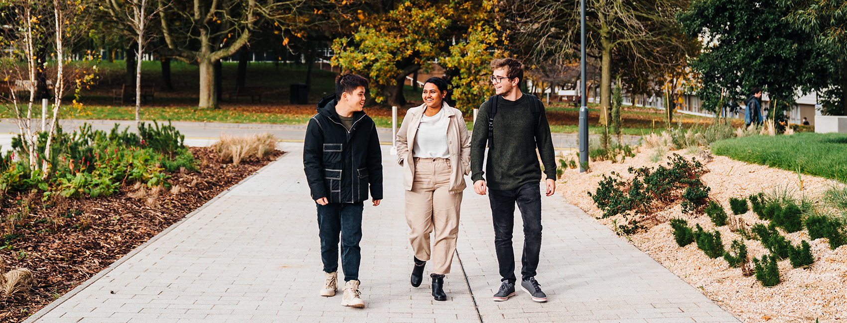 three economics students walking on campus