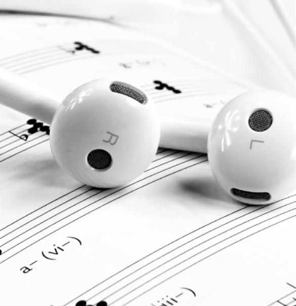 headphones on top of sheet of music