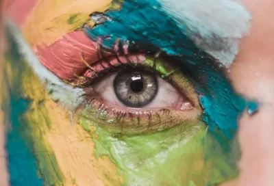 Picture of an eyeball with lots of colourful make-up