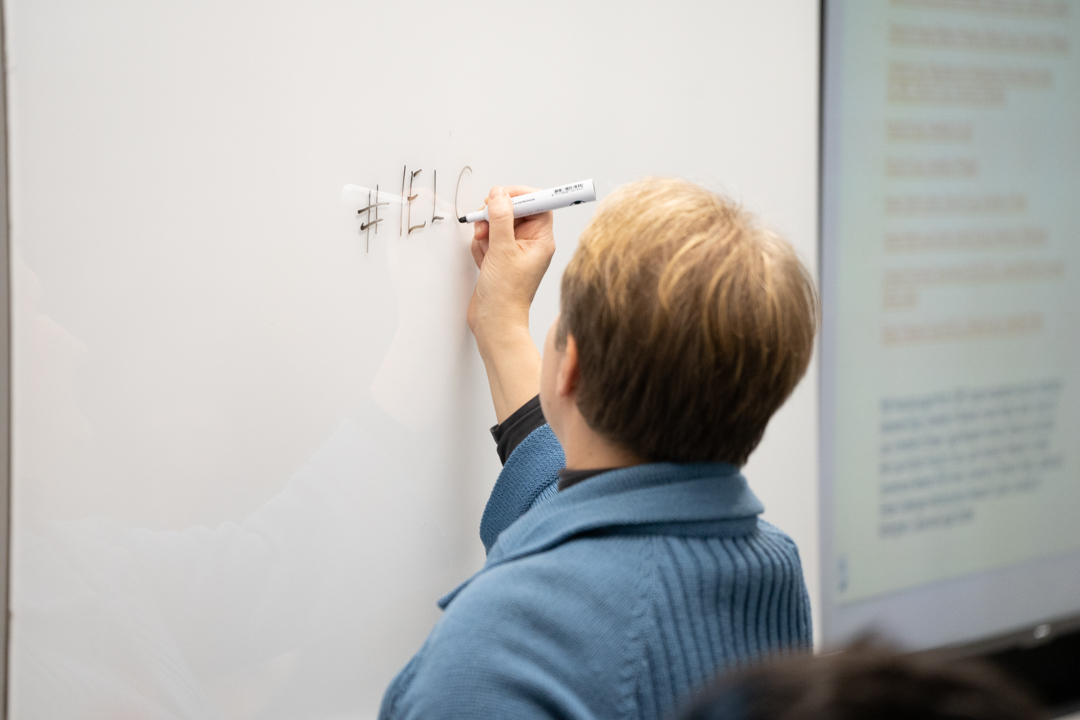 Person writing on whiteboard