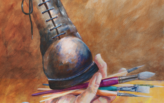 Boot on hand with paintbrushes