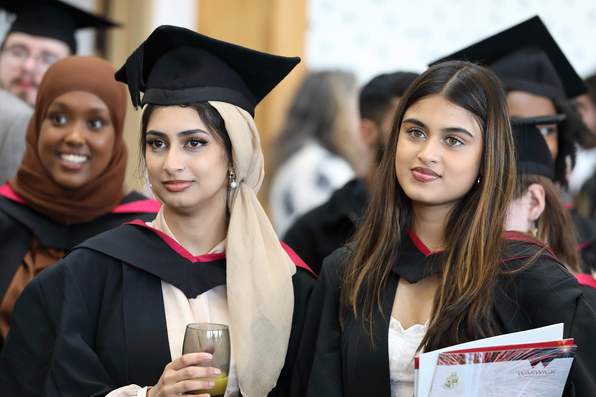 Three PAIS students in their graduation robes at the department's graduation reception.
