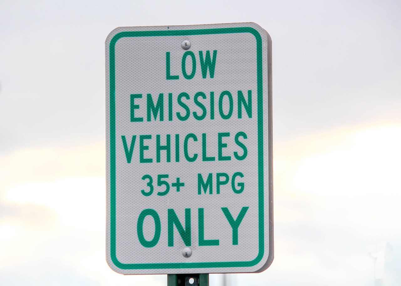 A road sign states that only low emission vehicles (35+ MPG) are allowed