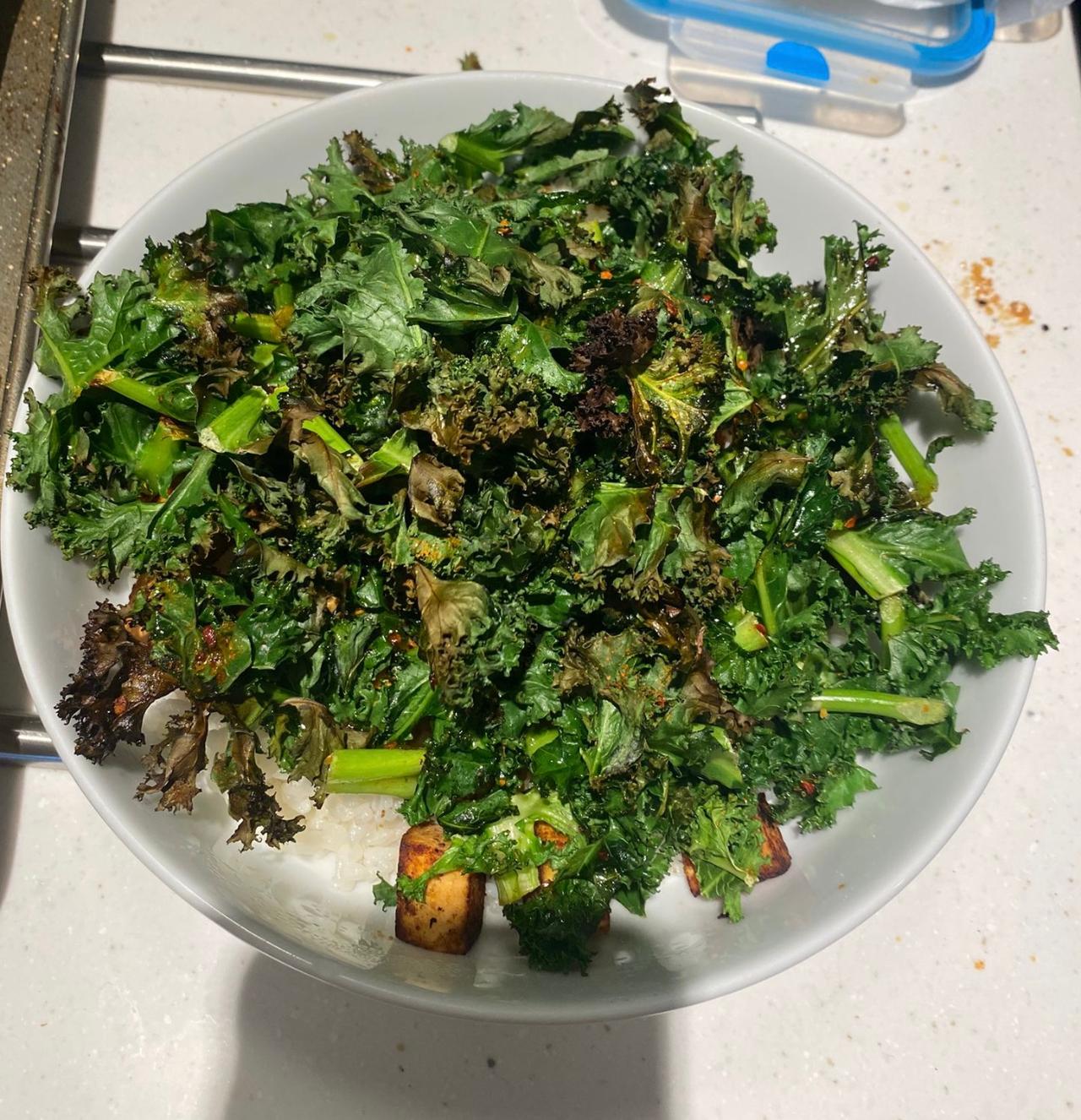 A bowl with sticky rice, tofu and kale