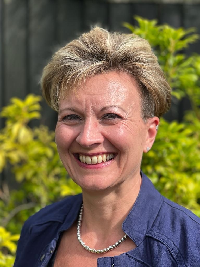 Nina-Anne standing in front of a tree looking at the camera