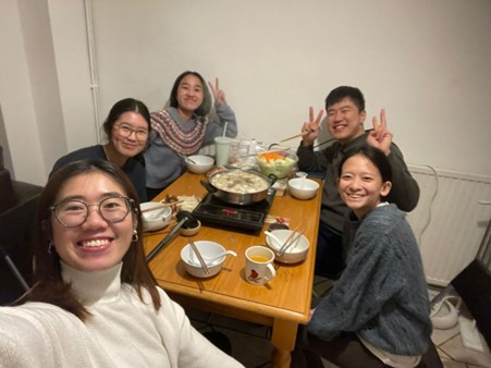 Housemates eating hotpot in the increasing cold weather 