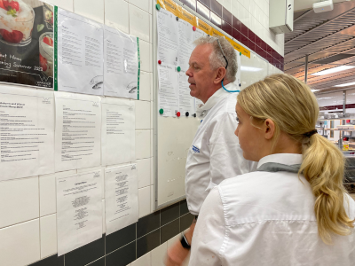 Image of Jessica looking at information in a University kitchen