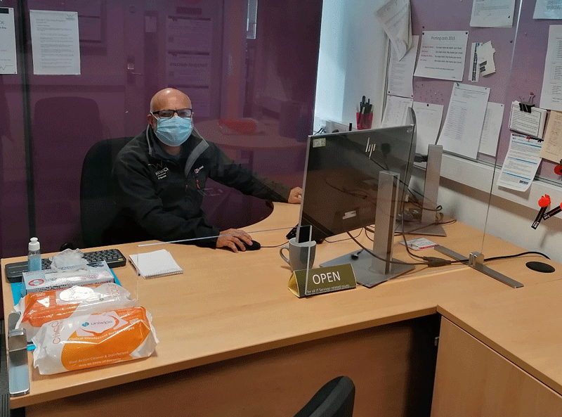 Dilip in his office during COVID wearing a mask