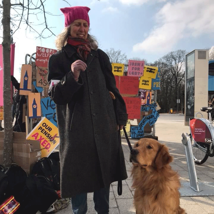 This photo shows Nickie and her dog Quince on the picket line during the UCU pension strike in February 2018.