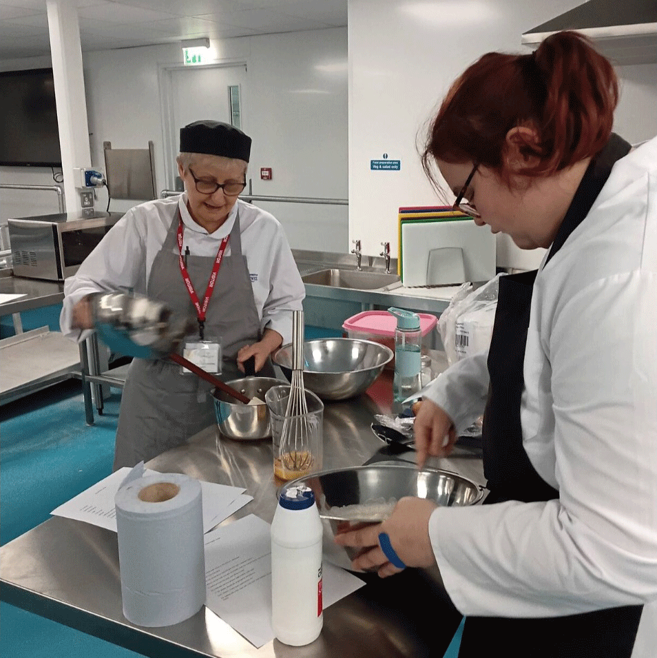 Valerie preparing food in the kitchen at Warwick.