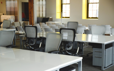 Image of desks and office chairs in an office space
